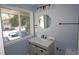 Bathroom vanity with storage, marble countertop, round mirror, and sleek hardware at 346 Carpenter Drive Ne Dr # 32, Sandy Springs, GA 30328