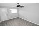 This bedroom features gray wood flooring, a ceiling fan, and a sunny window at 346 Carpenter Drive Ne Dr # 32, Sandy Springs, GA 30328