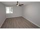 This bedroom features gray wood flooring, a ceiling fan, and a sunny window at 346 Carpenter Drive Ne Dr # 32, Sandy Springs, GA 30328