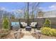 Backyard patio with outdoor seating and lighting features surrounded by pine straw at 347 Bailey Walk, Alpharetta, GA 30009