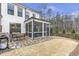 Landscaped backyard with stone patio, screened-in porch and outdoor seating area perfect for entertaining at 347 Bailey Walk, Alpharetta, GA 30009