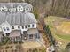 Backyard view features landscaping, a pond, and townhome exterior at 347 Bailey Walk, Alpharetta, GA 30009