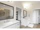 Spacious bathroom featuring double vanity sinks, granite countertops, and decorative tile at 347 Bailey Walk, Alpharetta, GA 30009