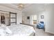 Bright bedroom featuring a sliding barn door, ensuite bath, tray ceiling, and large windows at 347 Bailey Walk, Alpharetta, GA 30009