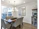 Elegant dining room featuring a wooden table, seating for four, a modern chandelier, and a wall mirror at 347 Bailey Walk, Alpharetta, GA 30009