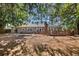 Extensive backyard with a wooden deck surrounded by mature trees, offering privacy and shade at 436 Carolwood Ln, Atlanta, GA 30342