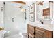 Renovated bathroom with a glass-enclosed shower, wood vanity, and elegant fixtures at 436 Carolwood Ln, Atlanta, GA 30342