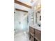 Updated bathroom featuring a marble-tiled shower, wooden vanity, and stylish fixtures at 436 Carolwood Ln, Atlanta, GA 30342