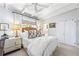 Bright bedroom featuring beamed ceilings, neutral decor, white bedding and curtains, and comfortable furnishings at 436 Carolwood Ln, Atlanta, GA 30342