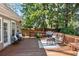 Wooden deck featuring outdoor furniture, surrounded by greenery, and accessible from the home at 436 Carolwood Ln, Atlanta, GA 30342