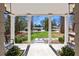 View from the covered front porch showing the landscaped yard and neighborhood homes at 436 Carolwood Ln, Atlanta, GA 30342