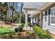 Cozy front porch with seating and manicured landscaping creating curb appeal at 436 Carolwood Ln, Atlanta, GA 30342