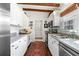 Galley kitchen featuring modern appliances, granite countertops, and stylish white cabinets at 436 Carolwood Ln, Atlanta, GA 30342