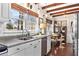 Sunlit kitchen with stainless steel appliances, double sink, and a view to the dining area at 436 Carolwood Ln, Atlanta, GA 30342