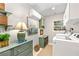 Well-appointed laundry room featuring a modern washer and dryer, custom shelving and a decorative painting at 436 Carolwood Ln, Atlanta, GA 30342