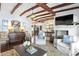 Cozy living room with white chairs, fireplace, exposed beam ceiling, and hardwood floors at 436 Carolwood Ln, Atlanta, GA 30342