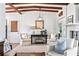 Living room area showcases natural light, exposed beams, fireplace, and hardwood floors at 436 Carolwood Ln, Atlanta, GA 30342