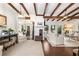 Spacious living room with exposed beams, fireplace, hardwood floors, and an adjacent dining area at 436 Carolwood Ln, Atlanta, GA 30342