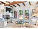 Bright living room features a fireplace, exposed beams and access to deck through glass doors at 436 Carolwood Ln, Atlanta, GA 30342