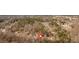 Neighborhood aerial view of homes in wooded setting with mature trees and a marked property location at 815 Oxford Hall Dr, Lawrenceville, GA 30044