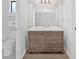 Stylish bathroom vanity with modern countertop, wood cabinets and large mirror, plus a separate toilet area at 815 Oxford Hall Dr, Lawrenceville, GA 30044