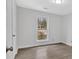 A bright bedroom with wood-look flooring and a window with natural light creates a serene and welcoming atmosphere at 815 Oxford Hall Dr, Lawrenceville, GA 30044