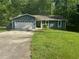 Charming single-story home featuring an attached garage and a well-maintained lawn at 815 Oxford Hall Dr, Lawrenceville, GA 30044