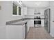Well-lit kitchen featuring granite countertops, stainless steel appliances, and ample cabinet space at 815 Oxford Hall Dr, Lawrenceville, GA 30044
