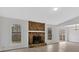 Cozy living room with a striking stone fireplace, white walls, and lots of natural light at 815 Oxford Hall Dr, Lawrenceville, GA 30044