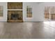 Spacious living area with an impressive stone fireplace and large windows with wood-look floors at 815 Oxford Hall Dr, Lawrenceville, GA 30044