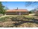 View of the rear of the house and backyard featuring a brown roof, and brown exterior at 131 Tye St, Stockbridge, GA 30281