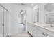 Bright bathroom with double vanity, tile floors, and glass-enclosed shower at 1744 Fawlocke Run, Loganville, GA 30052