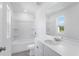 Well-lit bathroom featuring a tub-shower combo and a single sink vanity with white cabinets at 1744 Fawlocke Run, Loganville, GA 30052