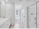 Bright bathroom featuring a single sink vanity with white cabinets and a glass enclosed shower at 1744 Fawlocke Run, Loganville, GA 30052