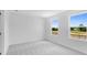 Bright bedroom featuring neutral carpet, white walls, large windows, and ample natural light at 1744 Fawlocke Run, Loganville, GA 30052