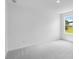 Bright bedroom features neutral carpet, white walls, a large window, and ample natural light at 1744 Fawlocke Run, Loganville, GA 30052