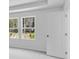 Bright bedroom featuring two windows offering natural light and views of the outside landscape at 1744 Fawlocke Run, Loganville, GA 30052