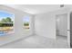 Bright bedroom featuring neutral carpet, white walls, large windows, and ample natural light at 1744 Fawlocke Run, Loganville, GA 30052