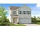 Charming two-story home with brick and siding exterior, well-manicured lawn, and inviting entry at 1744 Fawlocke Run, Loganville, GA 30052