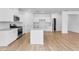 Open kitchen and living space with granite countertops and stainless steel appliances at 1744 Fawlocke Run, Loganville, GA 30052