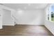 Bright living room featuring hardwood floors and large windows offering natural light at 1744 Fawlocke Run, Loganville, GA 30052