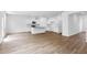 Open-concept living room featuring hardwood floors and a modern kitchen island at 1744 Fawlocke Run, Loganville, GA 30052