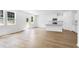 Open-concept living room featuring hardwood floors and a modern kitchen island at 1744 Fawlocke Run, Loganville, GA 30052