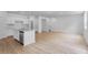 Open-concept living room with hardwood floors, stainless steel appliances, and island at 1744 Fawlocke Run, Loganville, GA 30052