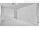 Neutral loft area with carpet, a window, and an open doorway at 1744 Fawlocke Run, Loganville, GA 30052
