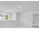 Bright upstairs loft area with two windows and a neutral color palette at 1744 Fawlocke Run, Loganville, GA 30052