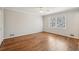 A large, bright bedroom featuring hardwood floors, a ceiling fan, and a big window at 2773 Townley Cir, Atlanta, GA 30340