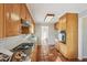 Galley kitchen with granite countertops, tile backsplash, modern appliances, and terra cotta tile flooring at 2773 Townley Cir, Atlanta, GA 30340