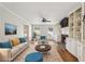 Staged living room featuring a fireplace with built-ins, hardwood floors, and neutral-toned furniture at 2773 Townley Cir, Atlanta, GA 30340