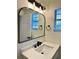 Elegant bathroom featuring a large mirror and modern sink with white countertop and black hardware at 3113 Bellgreen Way, Decatur, GA 30032